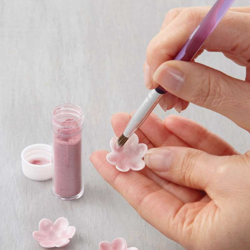 Zestaw pędzli Wilton podczas dekorowania kolorowego tortu